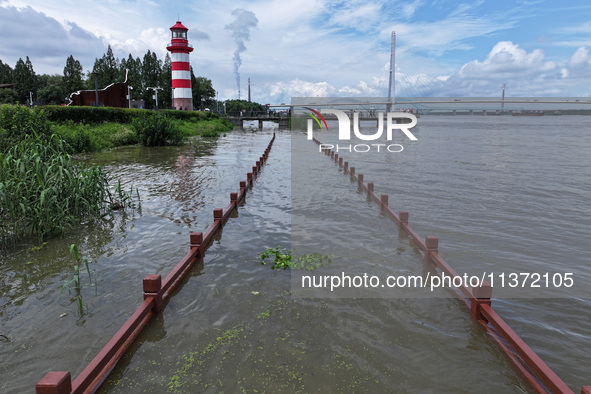 A flooded walkway is being seen after the Yangtze River is exceeding its warning level in Nanjing, Jiangsu province, China, on June 30, 2024...