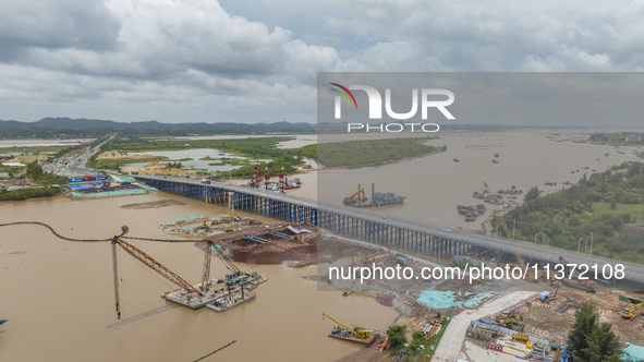 A photo is showing the construction site near Baotong Bridge of Shajing Qinjiang Bridge in Qinzhou, China, on June 29, 2024. 