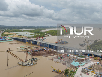 A photo is showing the construction site near Baotong Bridge of Shajing Qinjiang Bridge in Qinzhou, China, on June 29, 2024. (