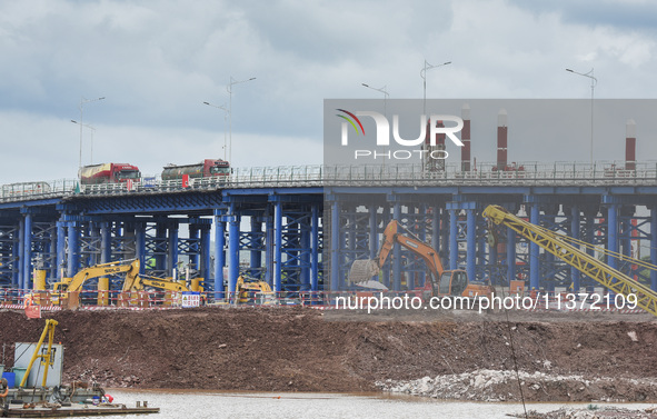 A photo is showing the construction site near Baotong Bridge of Shajing Qinjiang Bridge in Qinzhou, China, on June 29, 2024. 