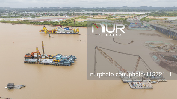 A large cutter suction dredger is under construction near the Qinjiang River Bridge at the mouth of the Qinjiang River in Qinzhou, China, on...