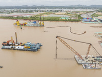 A large cutter suction dredger is under construction near the Qinjiang River Bridge at the mouth of the Qinjiang River in Qinzhou, China, on...