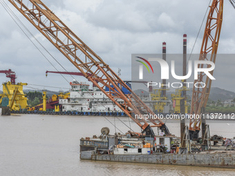 A large cutter suction dredger is under construction near the Qinjiang River Bridge at the mouth of the Qinjiang River in Qinzhou, China, on...