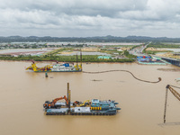 A large cutter suction dredger is under construction near the Qinjiang River Bridge at the mouth of the Qinjiang River in Qinzhou, China, on...