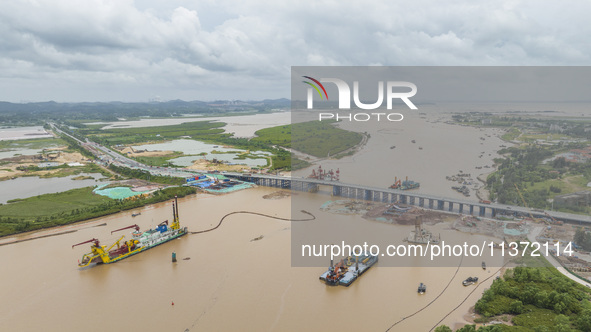 A large cutter suction dredger is under construction near the Qinjiang River Bridge at the mouth of the Qinjiang River in Qinzhou, China, on...