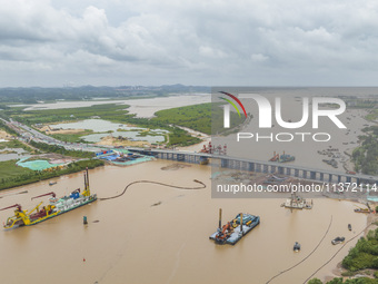 A large cutter suction dredger is under construction near the Qinjiang River Bridge at the mouth of the Qinjiang River in Qinzhou, China, on...