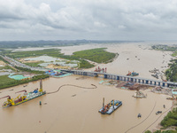 A large cutter suction dredger is under construction near the Qinjiang River Bridge at the mouth of the Qinjiang River in Qinzhou, China, on...