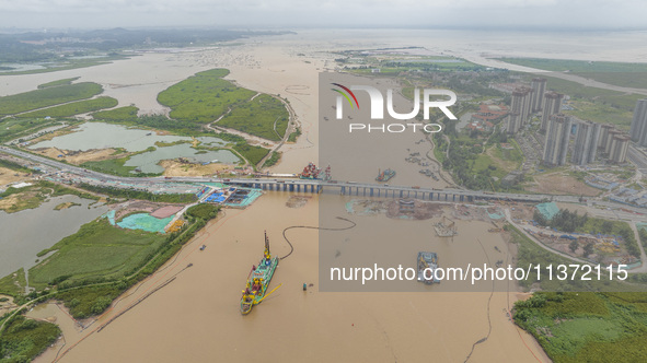 A large cutter suction dredger is under construction near the Qinjiang River Bridge at the mouth of the Qinjiang River in Qinzhou, China, on...