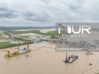 A large cutter suction dredger is under construction near the Qinjiang River Bridge at the mouth of the Qinjiang River in Qinzhou, China, on...