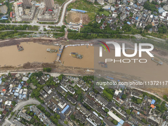 A photo is showing the construction site near Baotong Bridge of Shajing Qinjiang Bridge in Qinzhou, China, on June 29, 2024. (