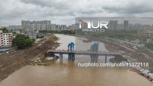 A photo is showing the construction site near Baotong Bridge of Shajing Qinjiang Bridge in Qinzhou, China, on June 29, 2024. 