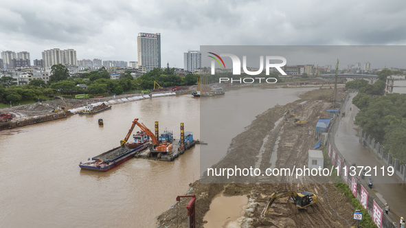 A photo is showing the construction site near Baotong Bridge of Shajing Qinjiang Bridge in Qinzhou, China, on June 29, 2024. 