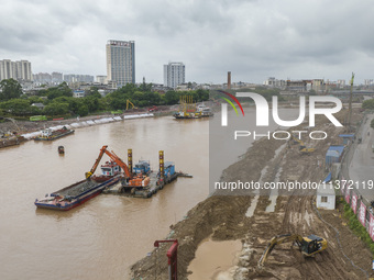 A photo is showing the construction site near Baotong Bridge of Shajing Qinjiang Bridge in Qinzhou, China, on June 29, 2024. (