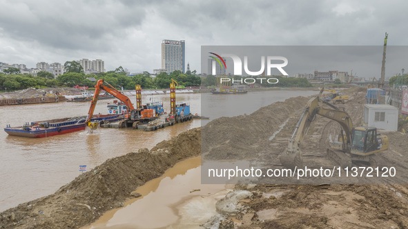 A photo is showing the construction site near Baotong Bridge of Shajing Qinjiang Bridge in Qinzhou, China, on June 29, 2024. 