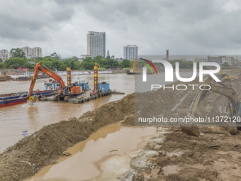 A photo is showing the construction site near Baotong Bridge of Shajing Qinjiang Bridge in Qinzhou, China, on June 29, 2024. (