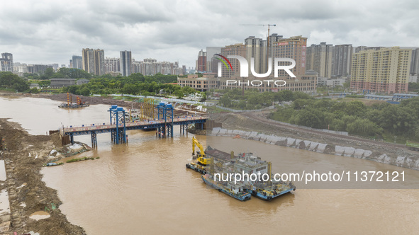 A photo is showing the construction site near Baotong Bridge of Shajing Qinjiang Bridge in Qinzhou, China, on June 29, 2024. 