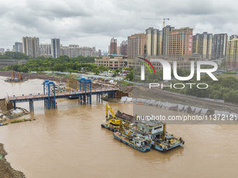 A photo is showing the construction site near Baotong Bridge of Shajing Qinjiang Bridge in Qinzhou, China, on June 29, 2024. (