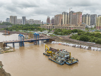 A photo is showing the construction site near Baotong Bridge of Shajing Qinjiang Bridge in Qinzhou, China, on June 29, 2024. (