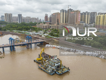 A photo is showing the construction site near Baotong Bridge of Shajing Qinjiang Bridge in Qinzhou, China, on June 29, 2024. (