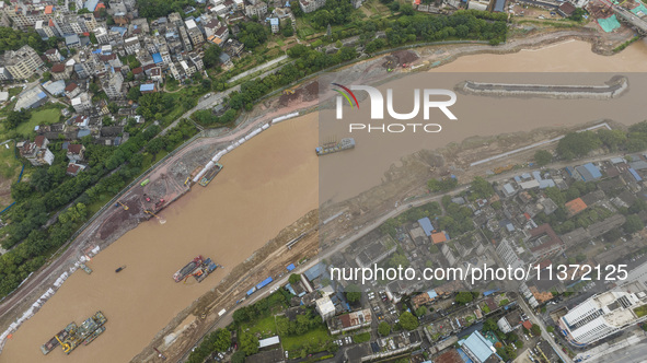 A photo is showing the construction site near Baotong Bridge of Shajing Qinjiang Bridge in Qinzhou, China, on June 29, 2024. 