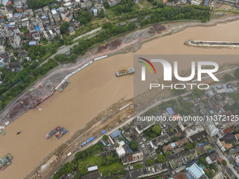 A photo is showing the construction site near Baotong Bridge of Shajing Qinjiang Bridge in Qinzhou, China, on June 29, 2024. (