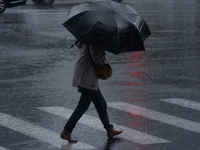 A woman is walking with an umbrella in stormy weather in Shanghai, China, on June 30, 2024. (