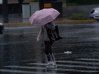 A woman is walking with an umbrella in stormy weather in Shanghai, China, on June 30, 2024. (