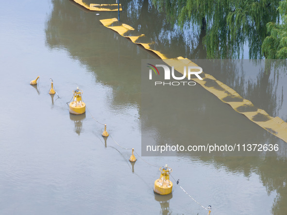 The water level of the Yangtze River is rising above the warning line in Nanjing, China, on June 30, 2024. 