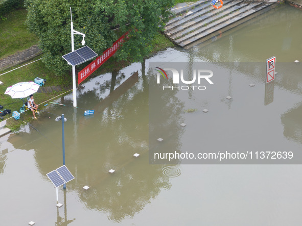 The water level of the Yangtze River is rising above the warning line in Nanjing, China, on June 30, 2024. 