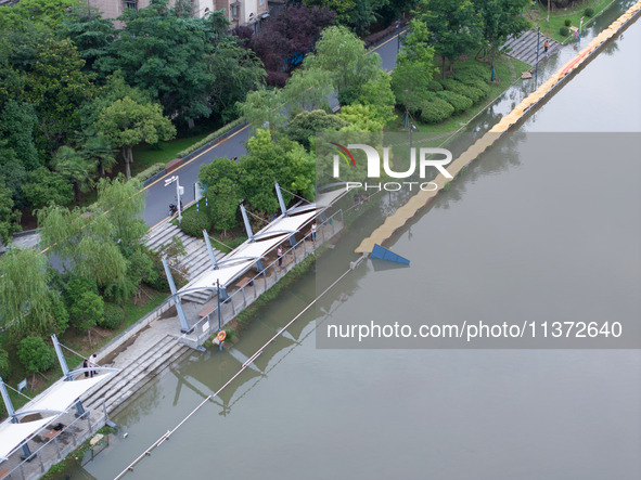 The water level of the Yangtze River is rising above the warning line in Nanjing, China, on June 30, 2024. 