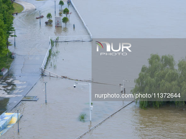 The water level of the Yangtze River is rising above the warning line in Nanjing, China, on June 30, 2024. 