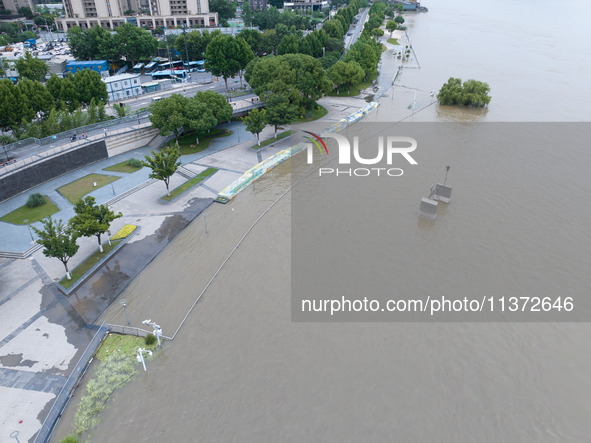 The water level of the Yangtze River is rising above the warning line in Nanjing, China, on June 30, 2024. 