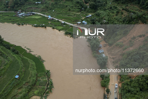 Workers are driving machinery to clear a collapsed road section at Bingmei Street in Congjiang county, Southwest China's Guizhou province, i...