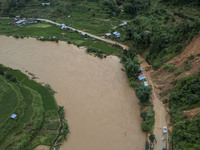 Workers are driving machinery to clear a collapsed road section at Bingmei Street in Congjiang county, Southwest China's Guizhou province, i...