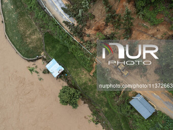 Workers are driving machinery to clear a collapsed road section at Bingmei Street in Congjiang county, Southwest China's Guizhou province, i...