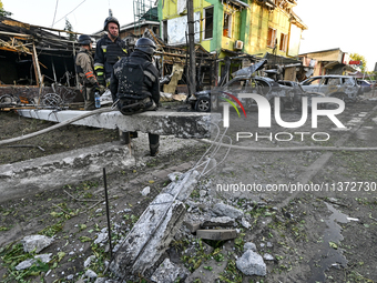 Rescuers are partaking in a response effort to the Russian missile attack in central Vilniansk, Zaporizhzhia region, southern Ukraine, on Ju...