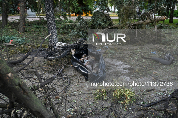 The body of a victim is lying on the ground in a body bag during a response effort to the Russian missile attack in central Vilniansk, Zapor...