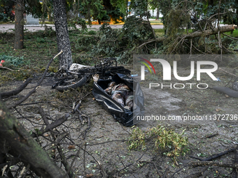 The body of a victim is lying on the ground in a body bag during a response effort to the Russian missile attack in central Vilniansk, Zapor...