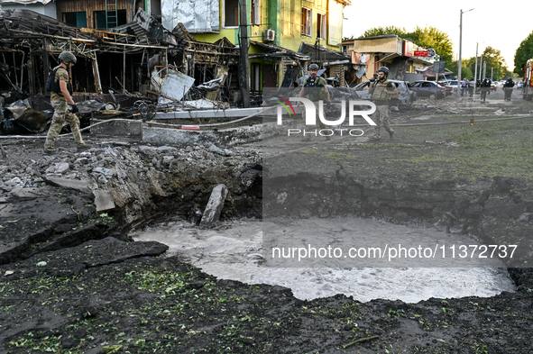 The crater from a Russian missile is being seen in the ground in central Vilniansk, Zaporizhzhia region, southern Ukraine, on June 29, 2024....