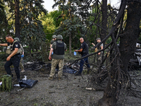 Criminal experts are examining the bodies of people killed by the Russian missile attack in central Vilniansk, Zaporizhzhia region, southern...