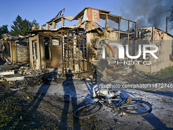 A man is walking past the body of a person killed by the Russian missile attack in central Vilniansk, Zaporizhzhia region, southern Ukraine,...