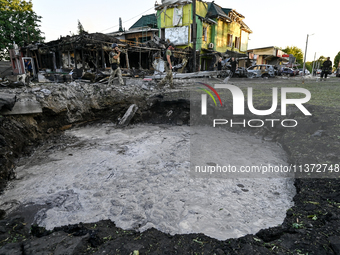 The crater from a Russian missile is being seen in the ground in central Vilniansk, Zaporizhzhia region, southern Ukraine, on June 29, 2024....