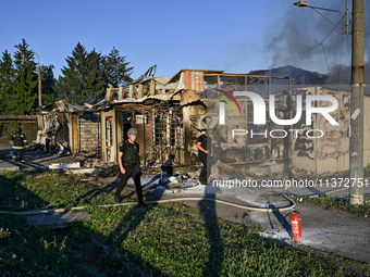 Rescuers are walking past the body of a person killed by the Russian missile attack in central Vilniansk, Zaporizhzhia region, southern Ukra...