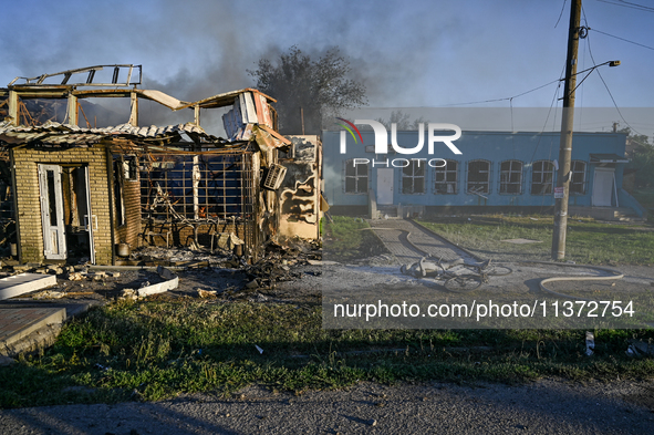 A man is walking past the body of a person killed by the Russian missile attack in central Vilniansk, Zaporizhzhia region, southern Ukraine,...