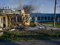 A man is walking past the body of a person killed by the Russian missile attack in central Vilniansk, Zaporizhzhia region, southern Ukraine,...