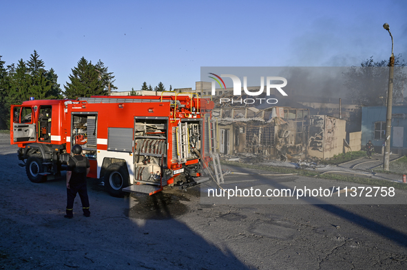 Firefighters are putting out a fire in a building during a response effort to the Russian missile attack in central Vilniansk, Zaporizhzhia...