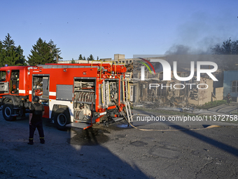 Firefighters are putting out a fire in a building during a response effort to the Russian missile attack in central Vilniansk, Zaporizhzhia...