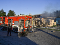 Firefighters are putting out a fire in a building during a response effort to the Russian missile attack in central Vilniansk, Zaporizhzhia...