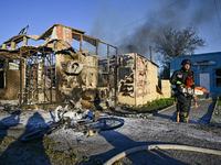 A rescuer is walking past the body of a person killed by the Russian missile attack in central Vilniansk, Zaporizhzhia region, southern Ukra...