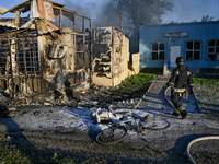 A rescuer is walking past the body of a person killed by the Russian missile attack in central Vilniansk, Zaporizhzhia region, southern Ukra...